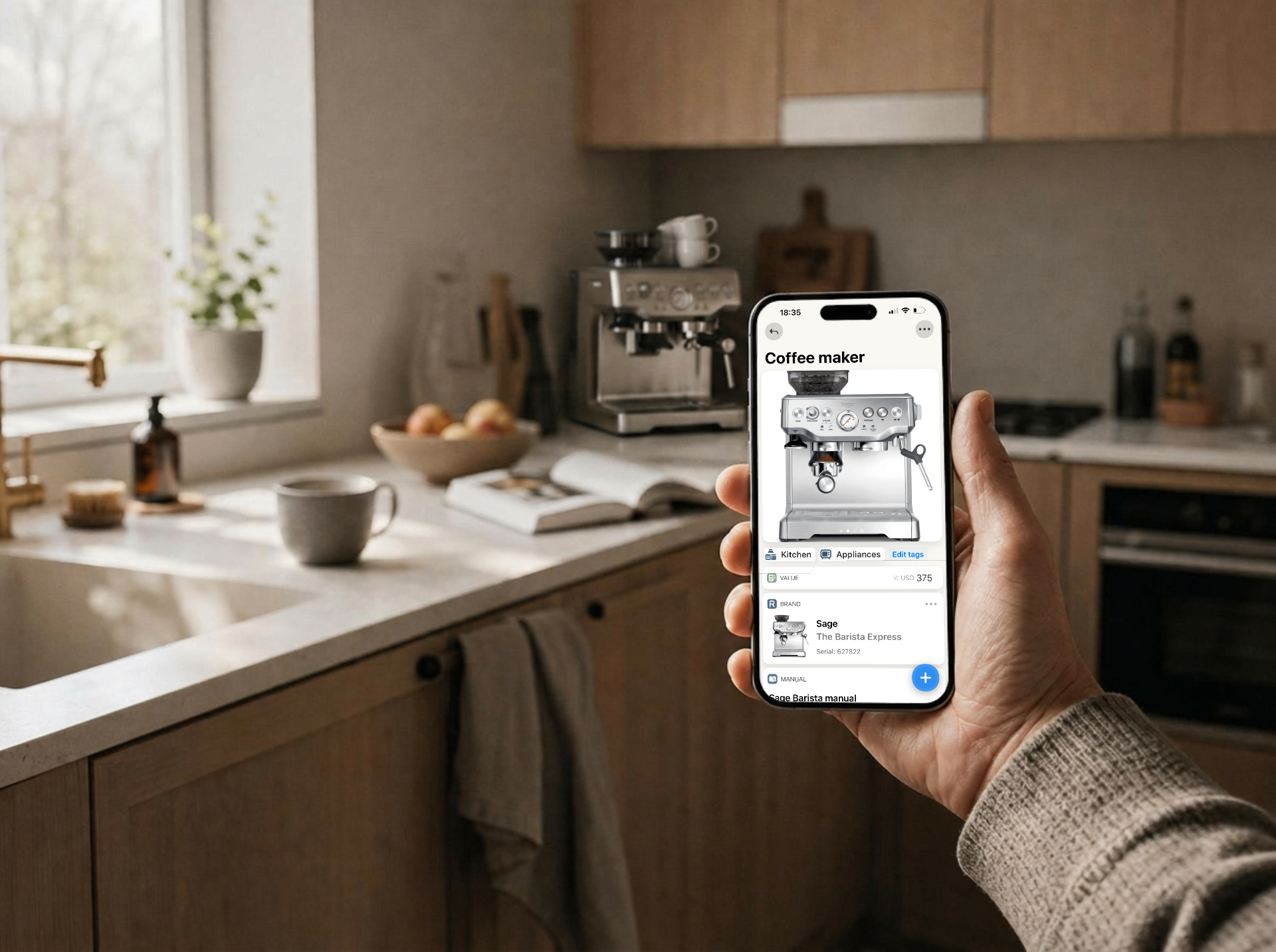 iPhone showing the Homer app held up inside a bright Nordic kitchen